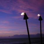 Romantic tiki torches blazing at sunset